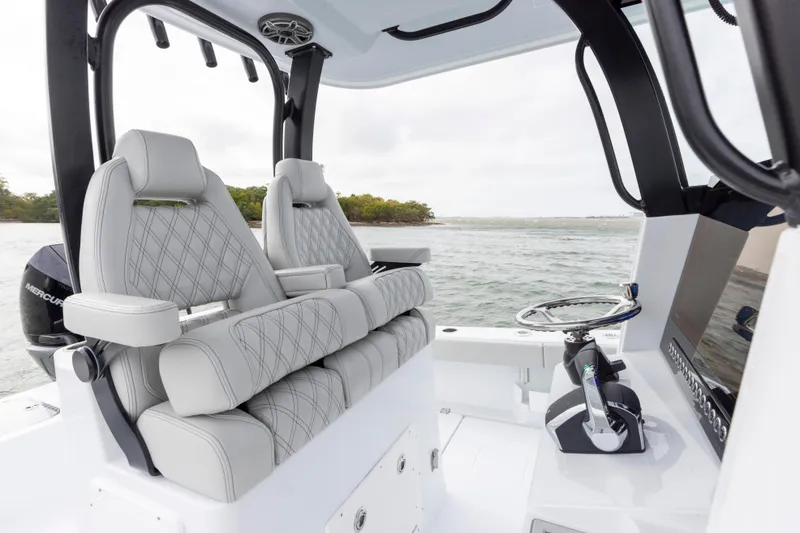 Slide: The Image of 2024 Freeman 28 boat interior with luxury seating and modern controls. - 20