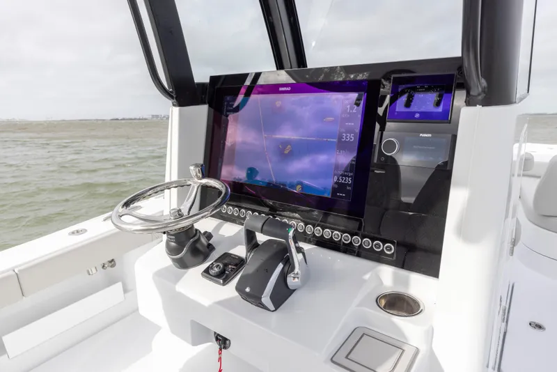 Slide: The Image of 2024 Freeman 28 boat dashboard with advanced navigation system and steering wheel. - 22