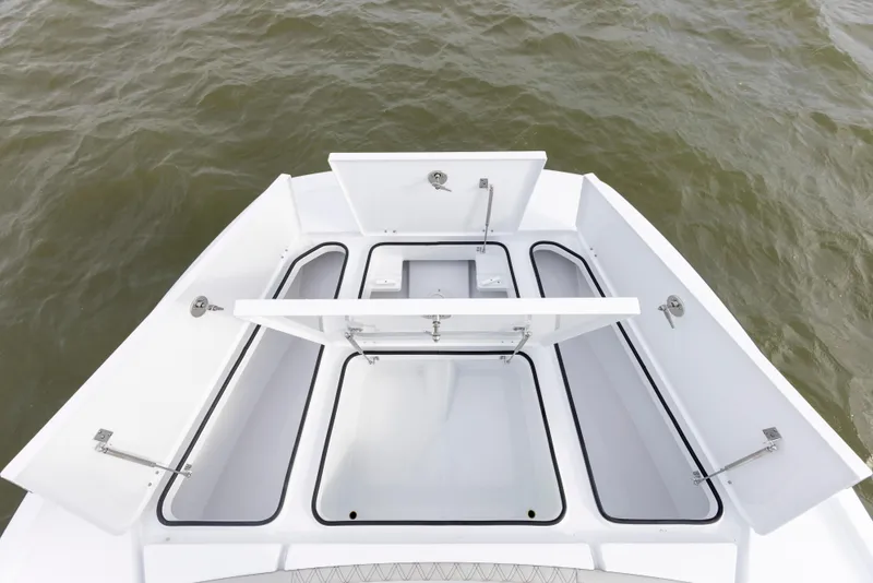 Slide: The Image of 2024 Freeman 28 boat storage compartments open on the deck. - 26