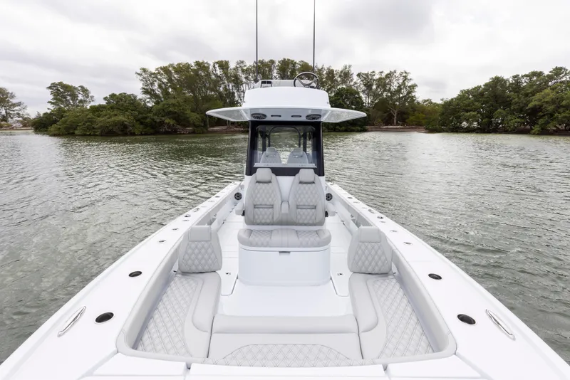 Slide: The Image of 2024 Freeman 28 boat with luxurious seating on calm water. - 27