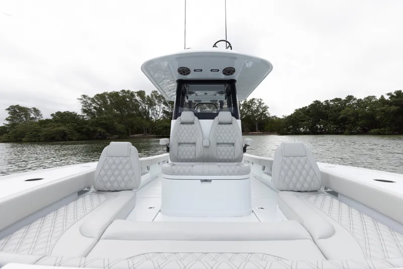 Slide: The Image of 2024 Freeman 28 boat with luxurious seating on a calm lake. - 28