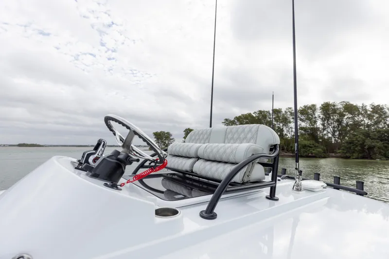 Slide: The Image of 2024 Freeman 28 boat helm with cushioned seating and steering wheel. - 29