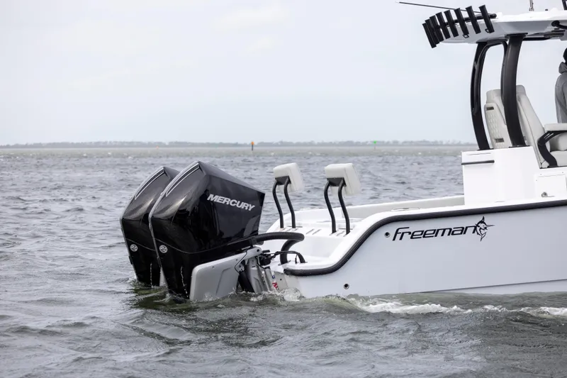 Slide: The Image of 2024 Freeman 28 boat with dual Mercury outboard engines on the water. - 4