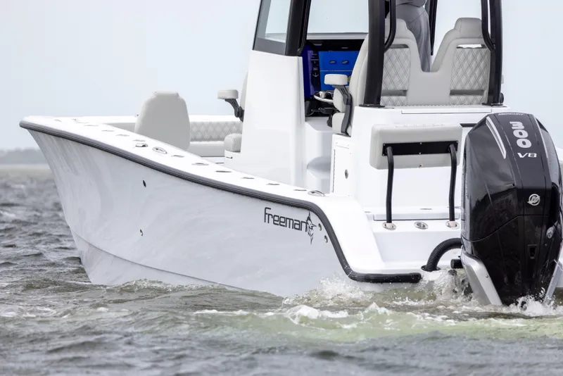 Slide: The Image of 2024 Freeman 28 boat with 300 V8 engine on water. - 6