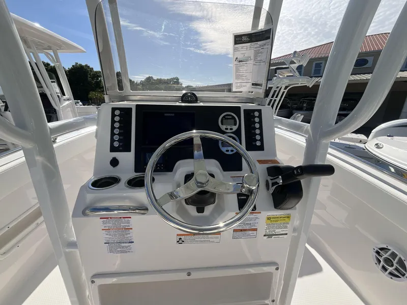 Slide: The Image of 2024 Robalo 222 Explore boat dashboard with steering wheel and control panel. - 11