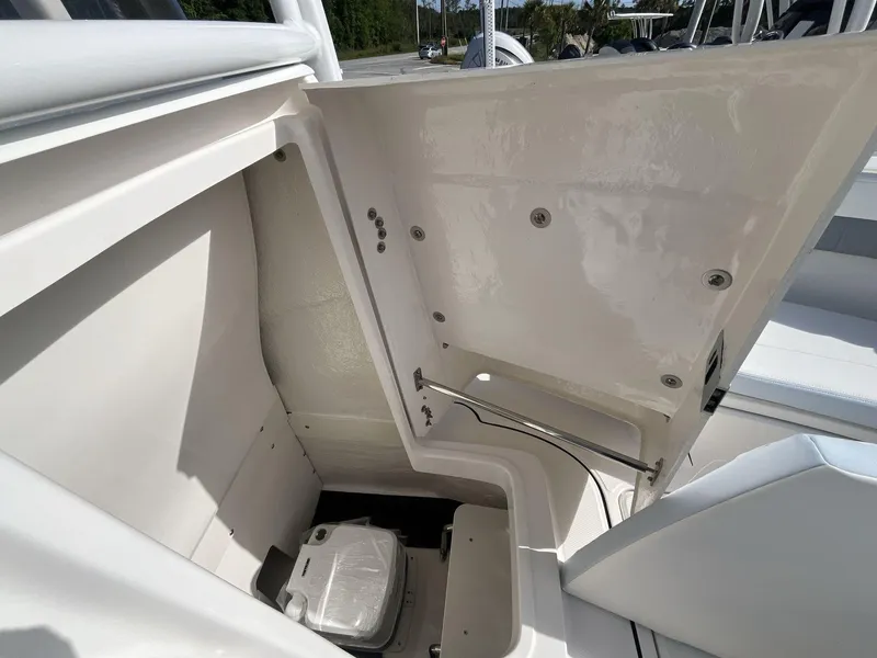 Slide: The Image of 2024 Robalo 222 Explore boat storage compartment with open hatch. - 14