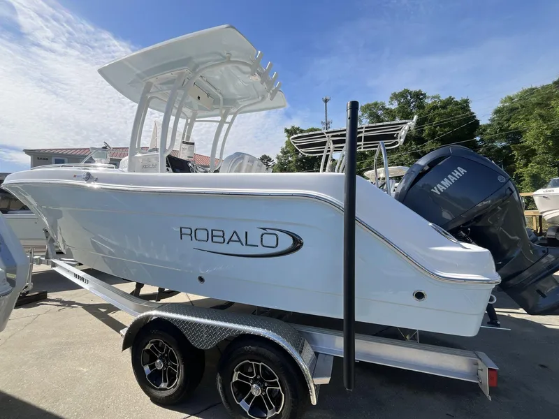 Slide: The Image of 2024 Robalo 222 Explore boat on a trailer, side view with Yamaha outboard motor. - 2
