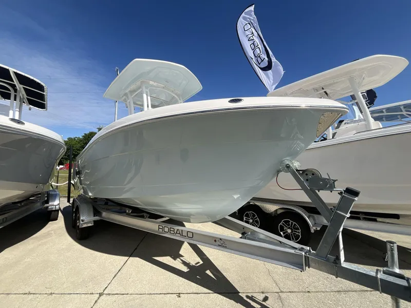 Slide: The Image of 2024 Robalo 222 Explore boat on a trailer, displayed outdoors. - 3
