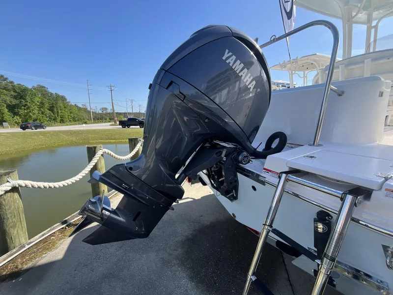 Slide: The Image of 2024 Robalo 222 Explore boat with Yamaha outboard motor at dock. - 5