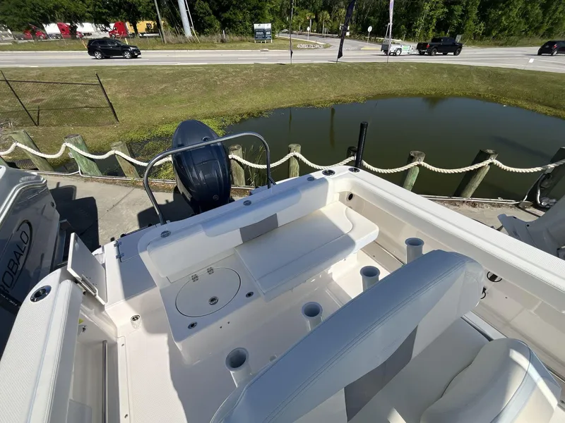 Slide: The Image of 2024 Robalo 222 Explore boat interior with seating and engine view. - 7