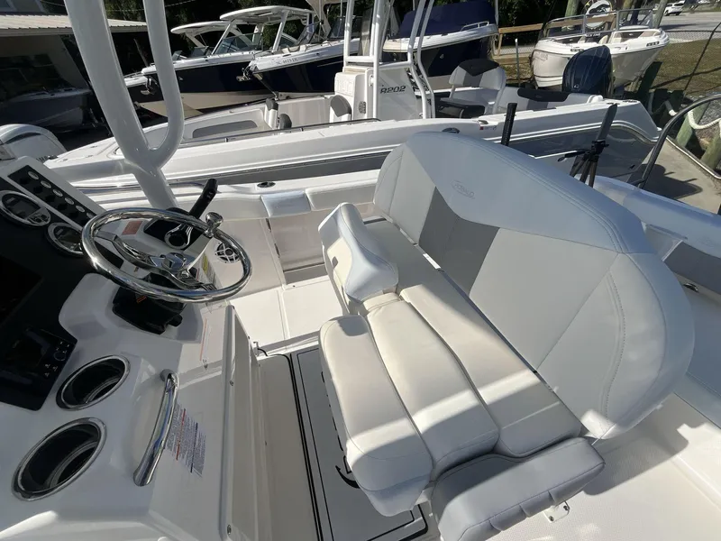 Slide: The Image of 2024 Robalo 222 Explore boat interior with steering wheel and seating. - 9