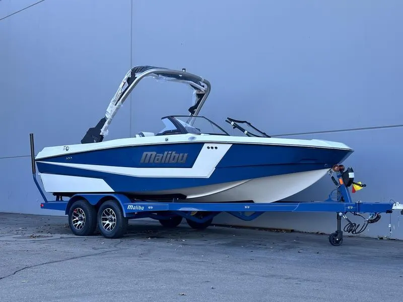 Slide: The Image of 2024 Malibu 21 LX-R boat on trailer, blue and white exterior. - 9