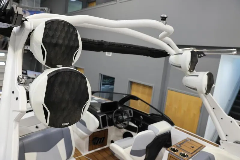 Slide: The Image of 2024 Malibu 24 MXZ boat interior with premium sound system and modern dashboard. - 12