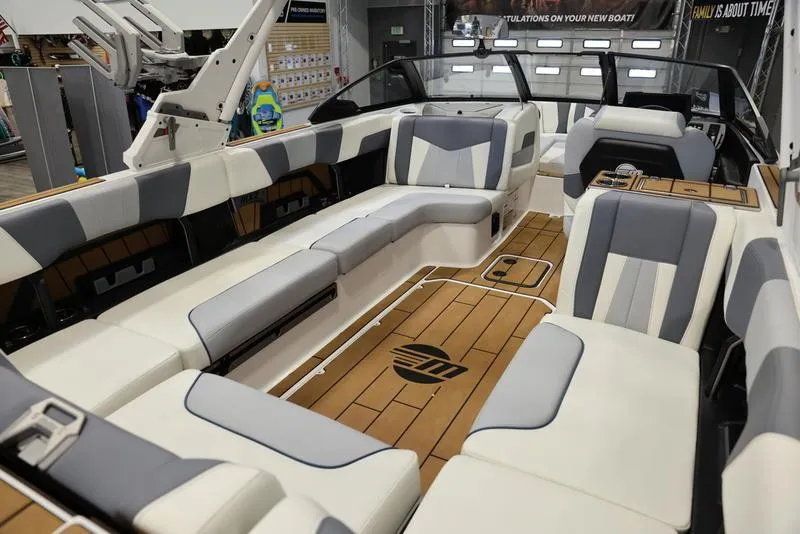 Slide: The Image of 2024 Malibu 24 MXZ boat interior with spacious seating and modern design. - 14