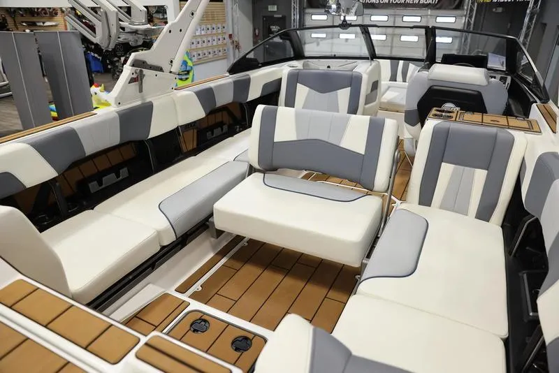 Slide: The Image of 2024 Malibu 24 MXZ boat interior with luxurious seating and modern design. - 18