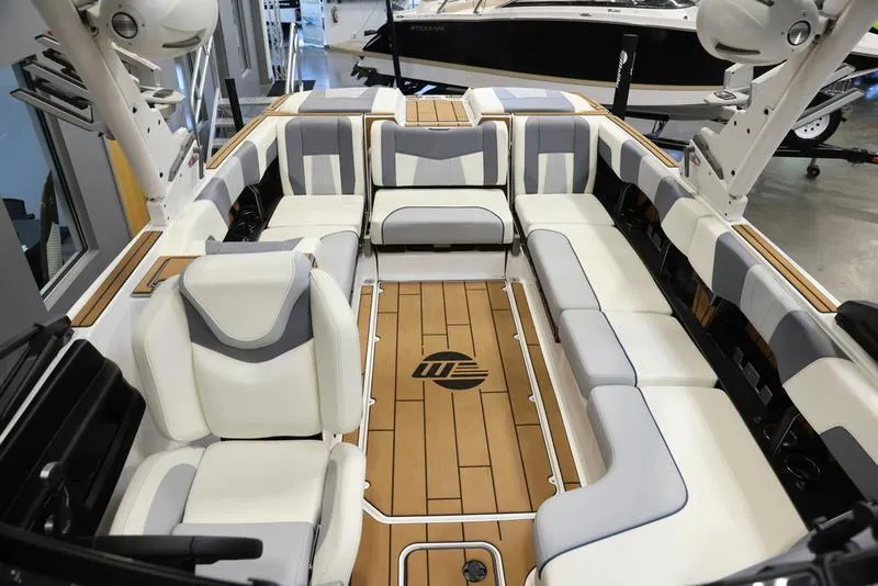 Slide: The Image of 2024 Malibu 24 MXZ boat interior with luxurious seating and teak flooring. - 20