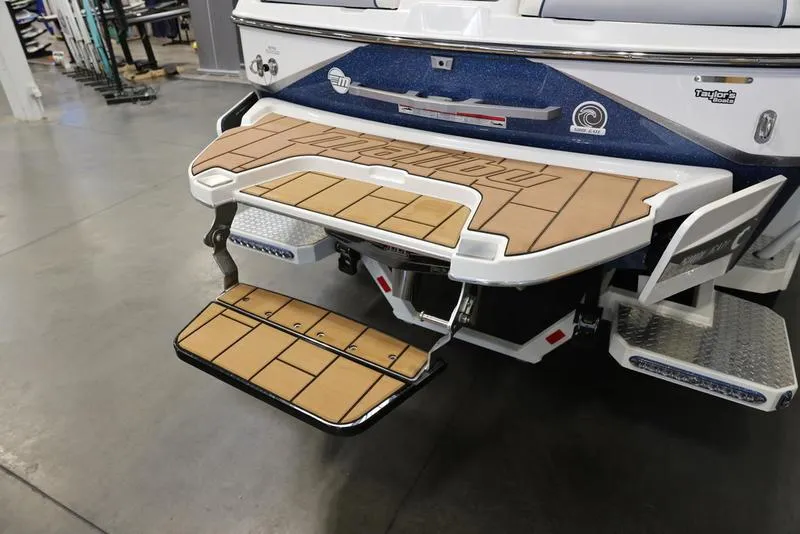 Slide: The Image of 2024 Malibu 24 MXZ boat swim platform with teak decking. - 21