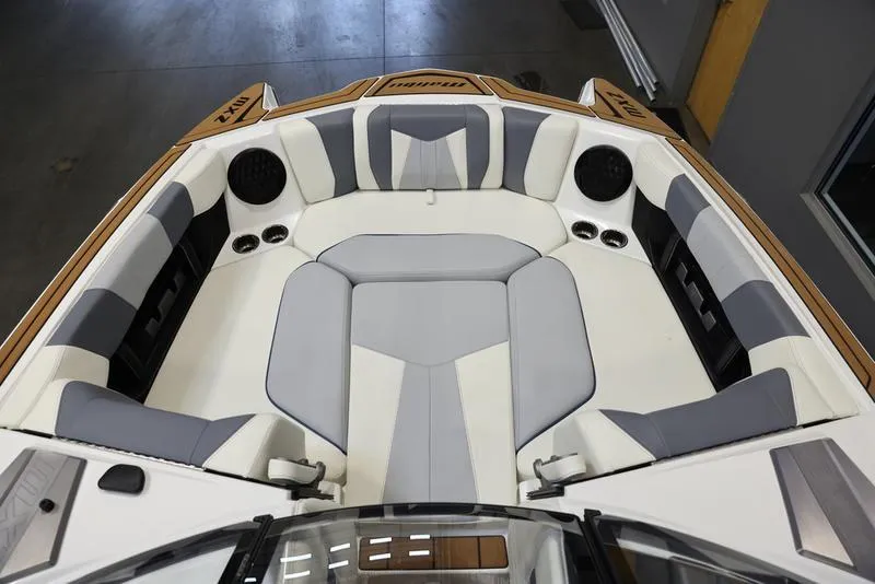 Slide: The Image of 2024 Malibu 24 MXZ boat interior with gray and white seating. - 3