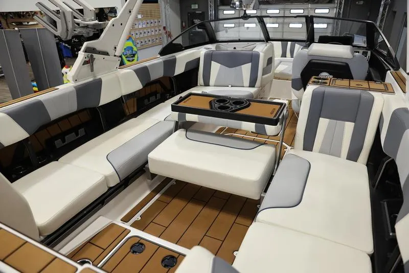 Slide: The Image of 2024 Malibu 24 MXZ boat interior with luxurious seating and table. - 5