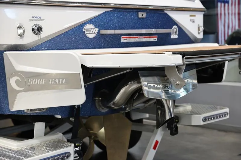 Slide: The Image of 2024 Malibu 24 MXZ boat rear view with Surf Gate and Power Wedge features. - 6