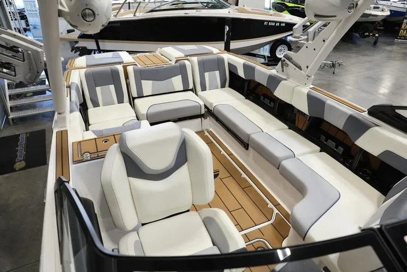 Slide: The Image of 2024 Malibu 24 MXZ boat interior with luxurious seating and modern design. - 9