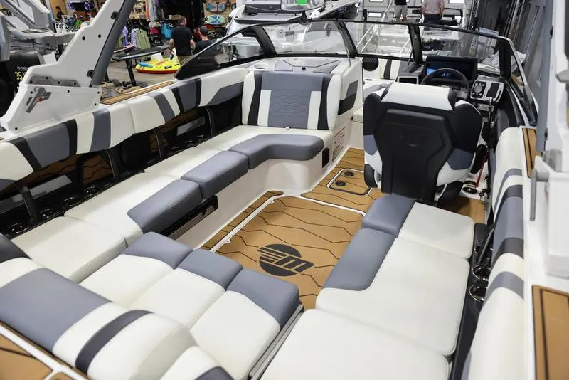 Slide: The Image of 2024 Malibu 23 MXZ boat interior with luxurious seating and modern design. - 13