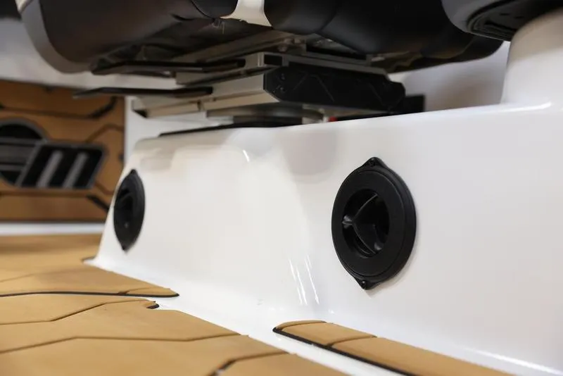 Slide: The Image of 2024 Malibu 23 MXZ boat interior with speakers and seating. - 14