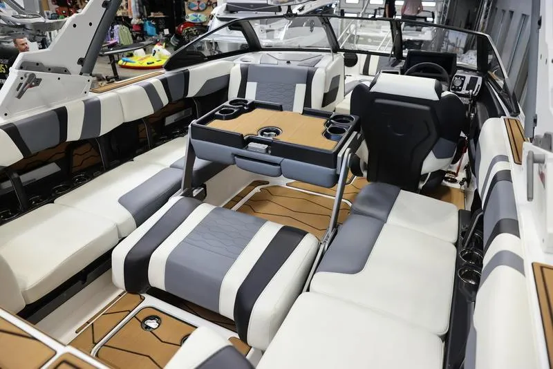 Slide: The Image of 2024 Malibu 23 MXZ boat interior with luxurious seating and modern amenities. - 15