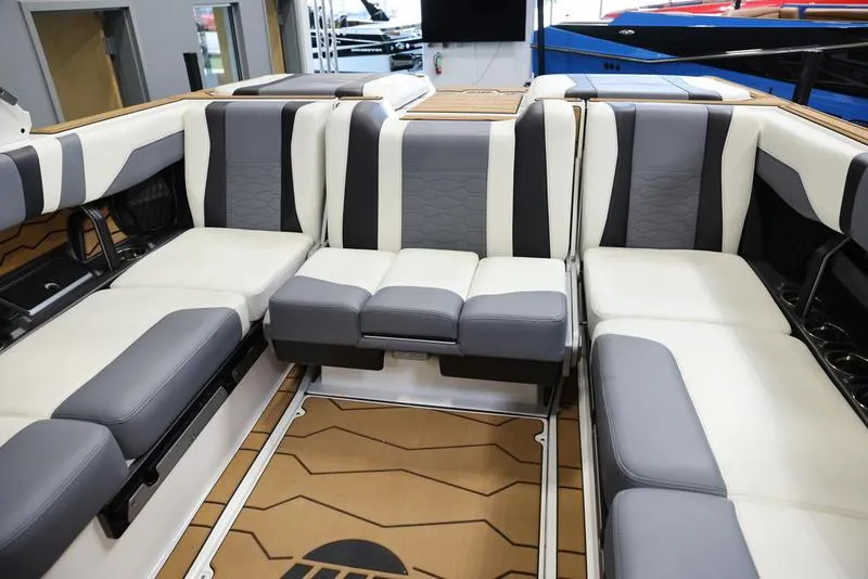 Slide: The Image of 2024 Malibu 23 MXZ boat interior with luxurious seating and modern design. - 16
