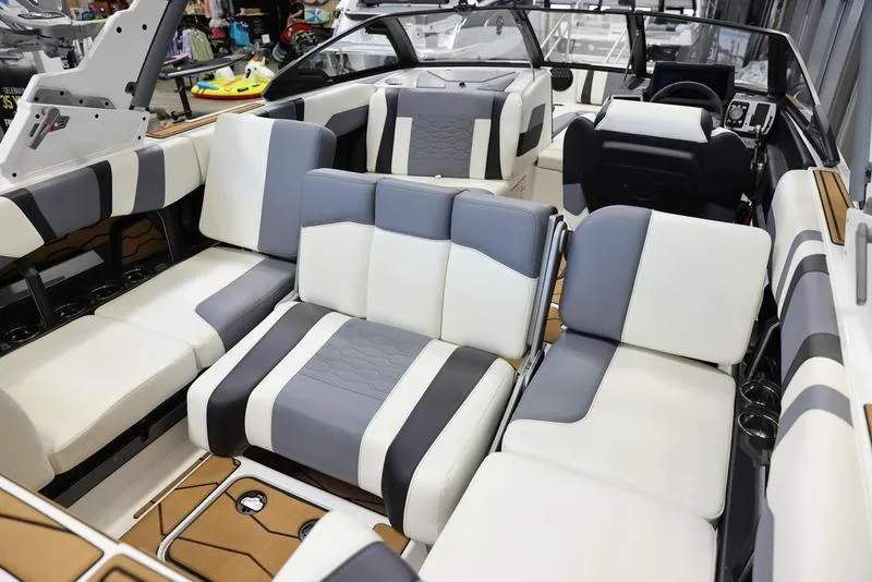 Slide: The Image of 2024 Malibu 23 MXZ boat interior with luxurious seating and modern design. - 17