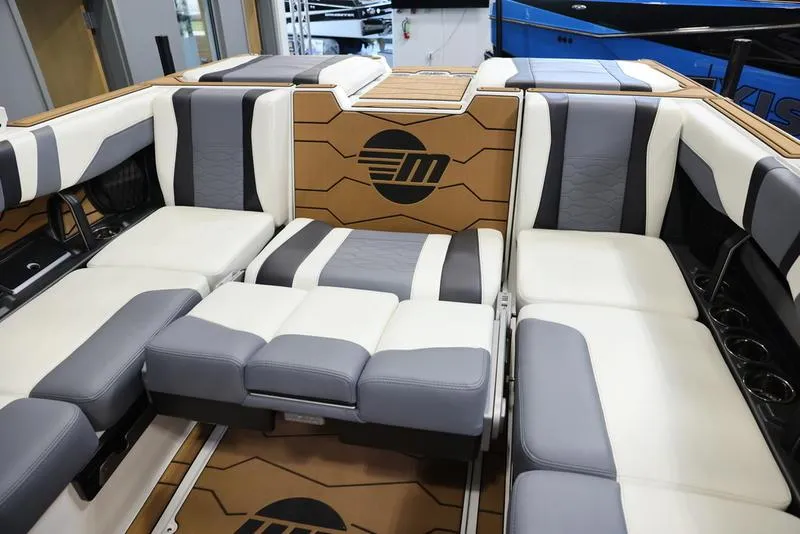 Slide: The Image of 2024 Malibu 23 MXZ boat interior with luxurious seating and modern design. - 18