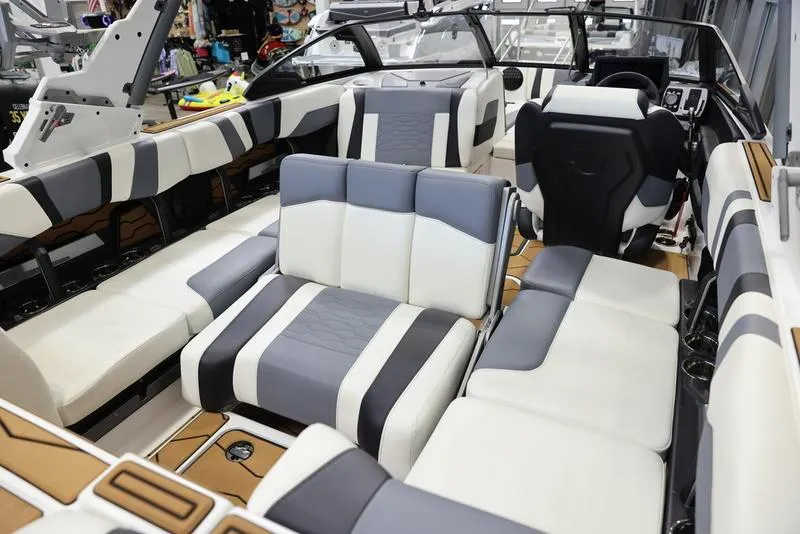 Slide: The Image of 2024 Malibu 23 MXZ boat interior with luxurious seating and modern design. - 19