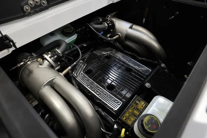 Slide: The Image of 2024 Malibu 23 MXZ boat engine with supercharger and advanced components. - 22