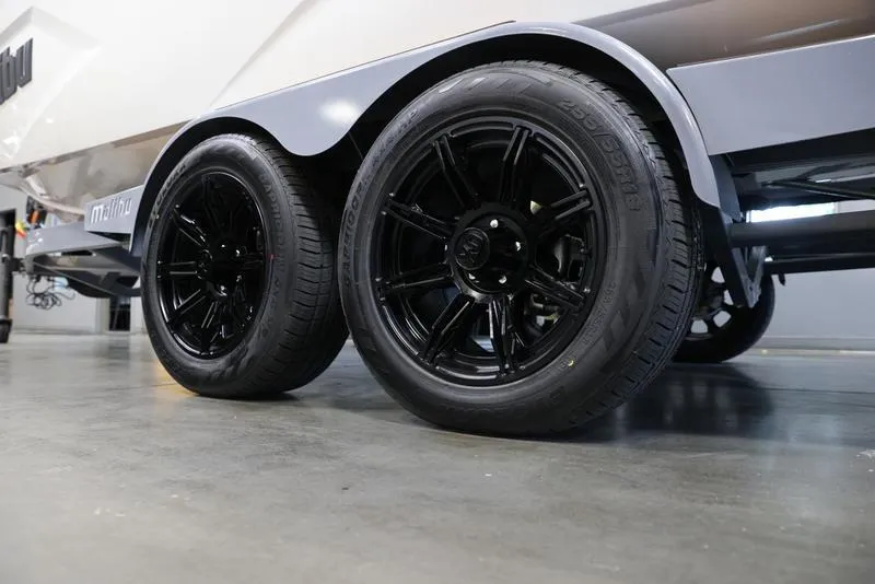 Slide: The Image of 2024 Malibu 23 MXZ boat trailer with black alloy wheels. - 3