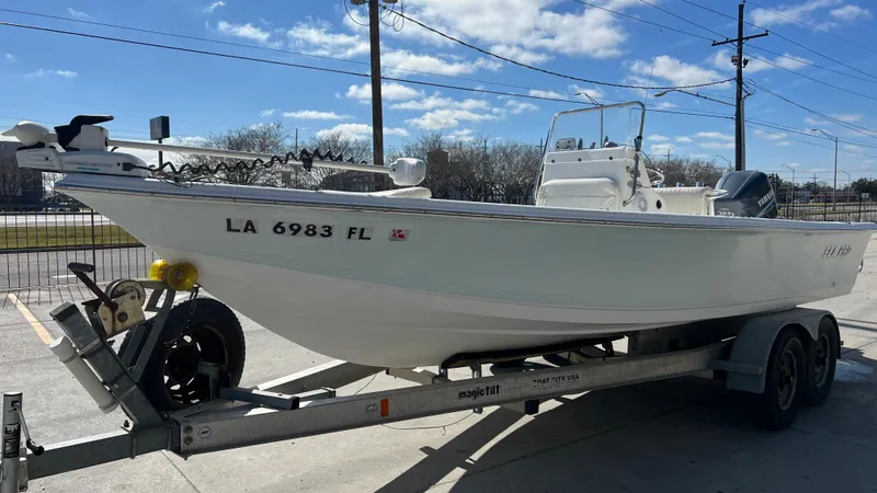 Slide: The Image of 2005 Sea Pro SV2100 CC boat on a trailer, side view, clear sky background. - 5