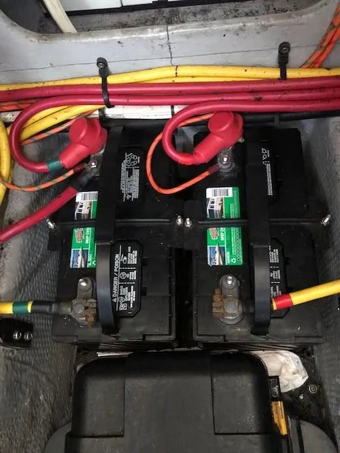 Slide: The Image of 2004 Silverton 34C boat battery compartment with wiring and dual batteries. - 10