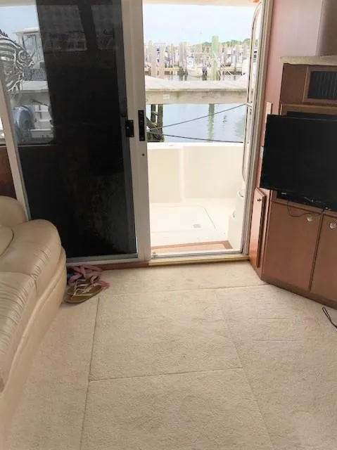 Slide: The Image of Interior view of 2004 Silverton 34C yacht with open sliding door to deck. - 26