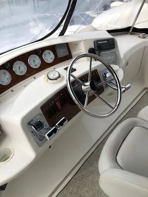 Slide: The Image of 2004 Silverton 34C boat helm with steering wheel and instrument panel. - 28