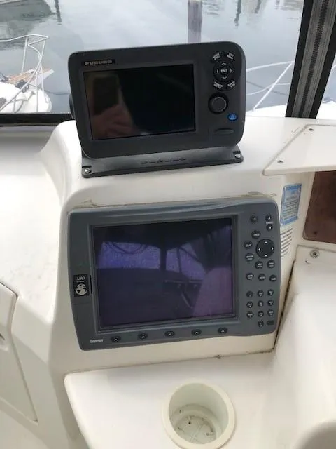 Slide: The Image of 2004 Silverton 34C boat dashboard with navigation equipment and controls. - 29