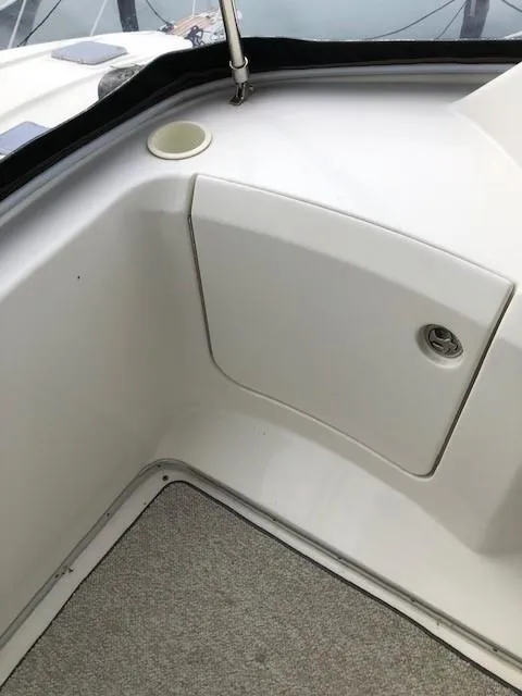 Slide: The Image of 2004 Silverton 34C boat interior with white panel and cup holder. - 30