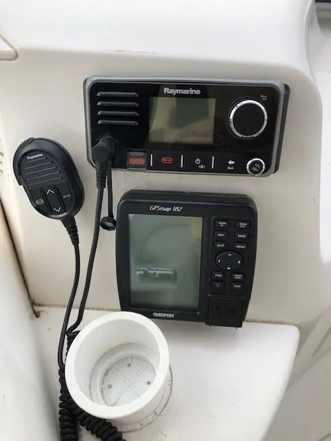 Slide: The Image of 2004 Silverton 34C boat dashboard with Raymarine radio and Garmin GPSmap 182. - 31