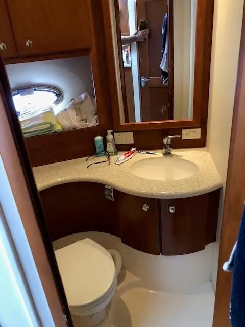Slide: The Image of Bathroom interior of a 2004 Silverton 34C yacht with sink and toilet. - 35