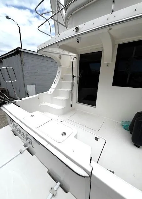 Slide: The Image of 2004 Silverton 34C yacht, white exterior, docked, featuring spacious deck and modern design. - 38