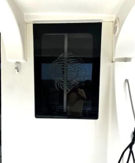 Slide: The Image of 2004 Silverton 34C boat window with etched fish design. - 40