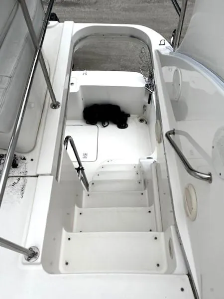 Slide: The Image of 2004 Silverton 34C boat interior stairs with railing, white finish, and storage compartment. - 43