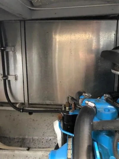 Slide: The Image of Engine compartment of a 2004 Silverton 34C boat, featuring visible blue engine components. - 8