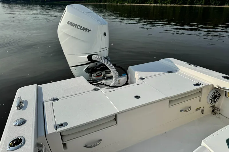 Slide: The Image of 2024 Everglades 253 Center Console boat with Mercury outboard engine on calm water. - 11