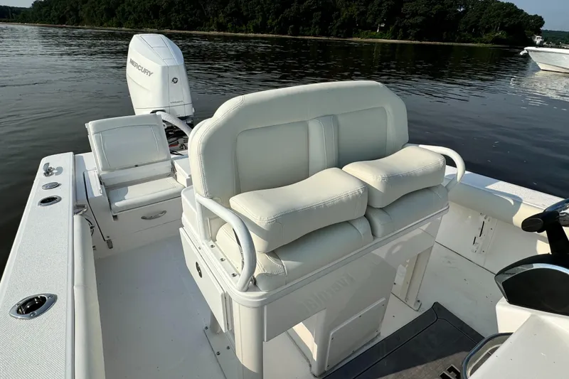 Slide: The Image of 2024 Everglades 253 Center Console boat interior with cushioned seating and Mercury outboard motor. - 14