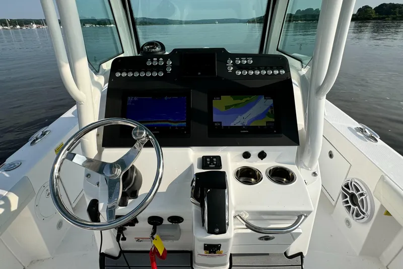 Slide: The Image of 2024 Everglades 253 Center Console boat helm with dual navigation screens. - 15