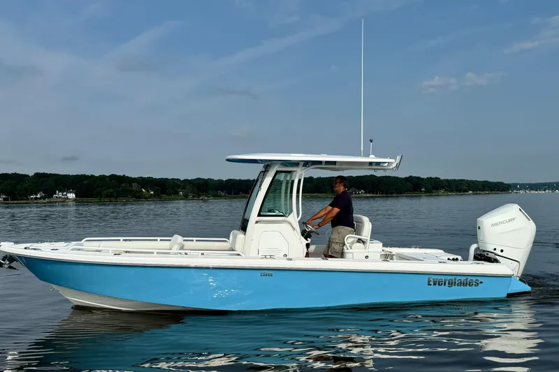 Slide: The Image of 2024 Everglades 253 Center Console boat on calm water. - 2